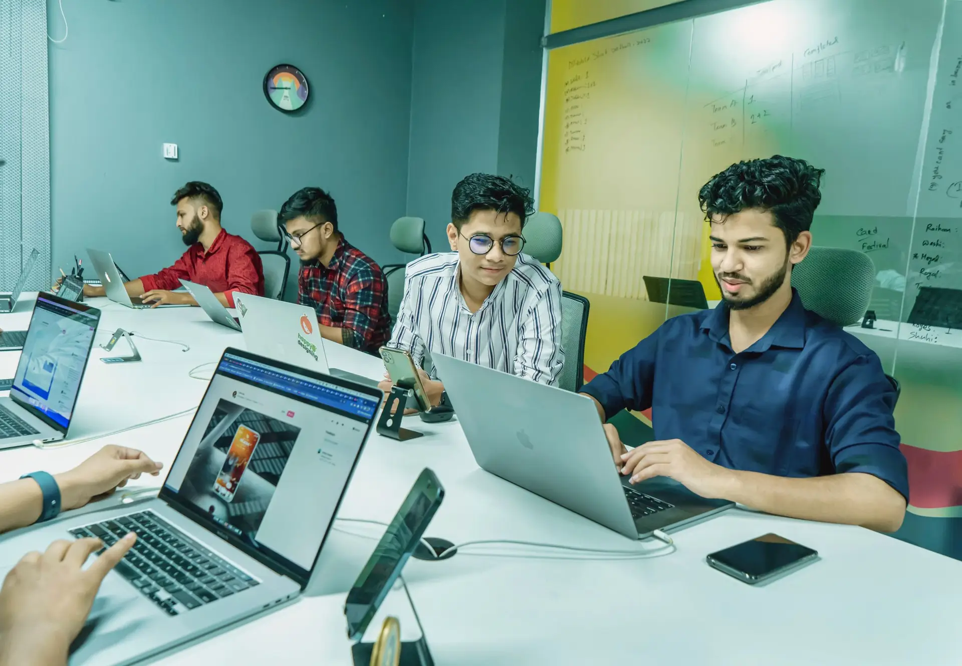 A small team working together on laptops in a modern office